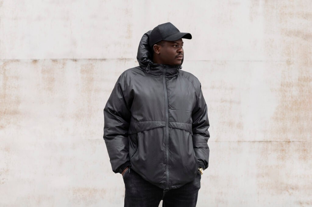 Man in black jacket and cap